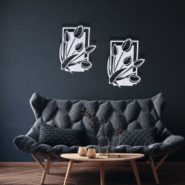 Modern black floral wooden wall art installed above chair and lamp