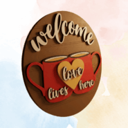 3D angled view of Welcome Love Lives Here wooden wall decor with layered coffee cup design