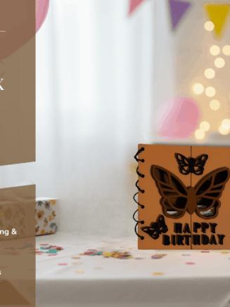 Vertical handcrafted butterfly birthday card with bold typography and butterfly motifs, placed on a wooden surface