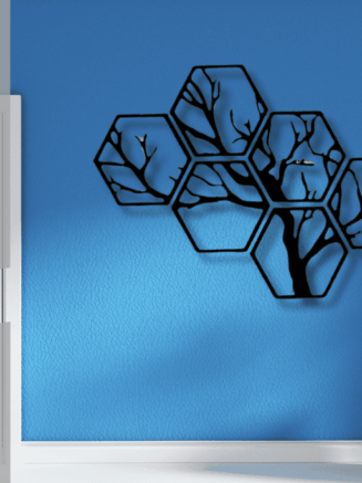 Black metal hexagon tree wall decor on green accent wall interior