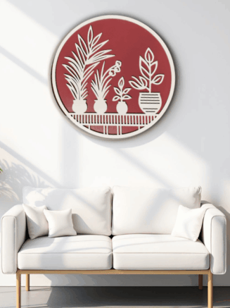 Plant craft wooden wall hanger in maroon color displayed above a modern white sofa with indoor plants
